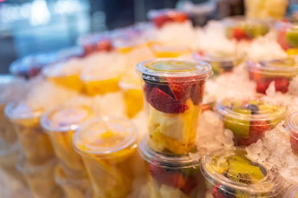 Fruit counted in individual containers ready for consumption and preserved with ice, Mercado de San Miguel, Madrid.