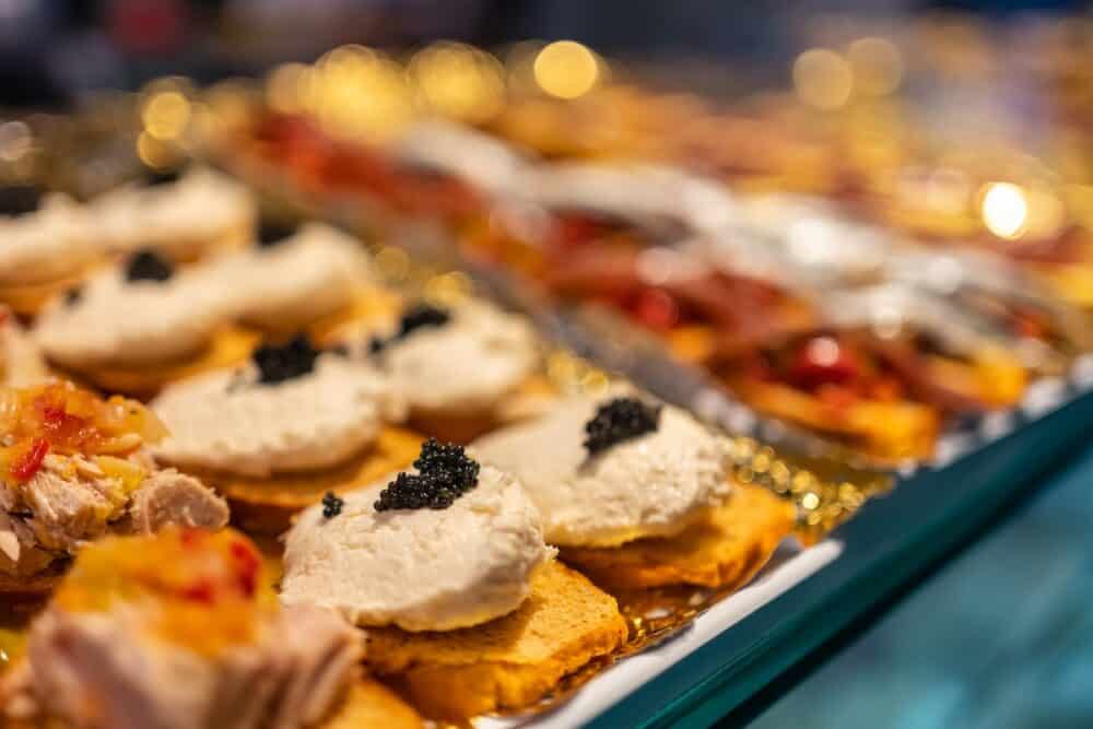 Tuna and caviar snacks displayed at a ready-to-eat counter, Mercado de San Miguel, Madrid.