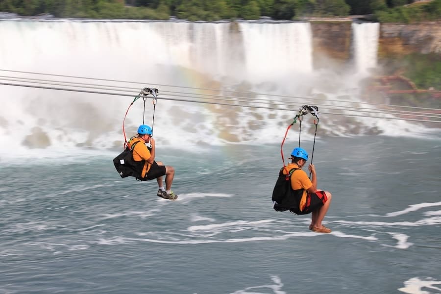 NIAGARA FALLS, ONTARIO. There's a new attraction in Niagara Falls as we see two people heading toward the falls. For the brave at heart you can zipline along the escarpment of the Canadian side to a platform below and close to the Horseshoe