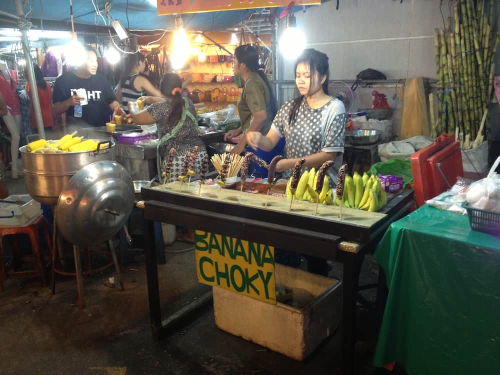 Lady serving chocolate bananas in Phuket Market