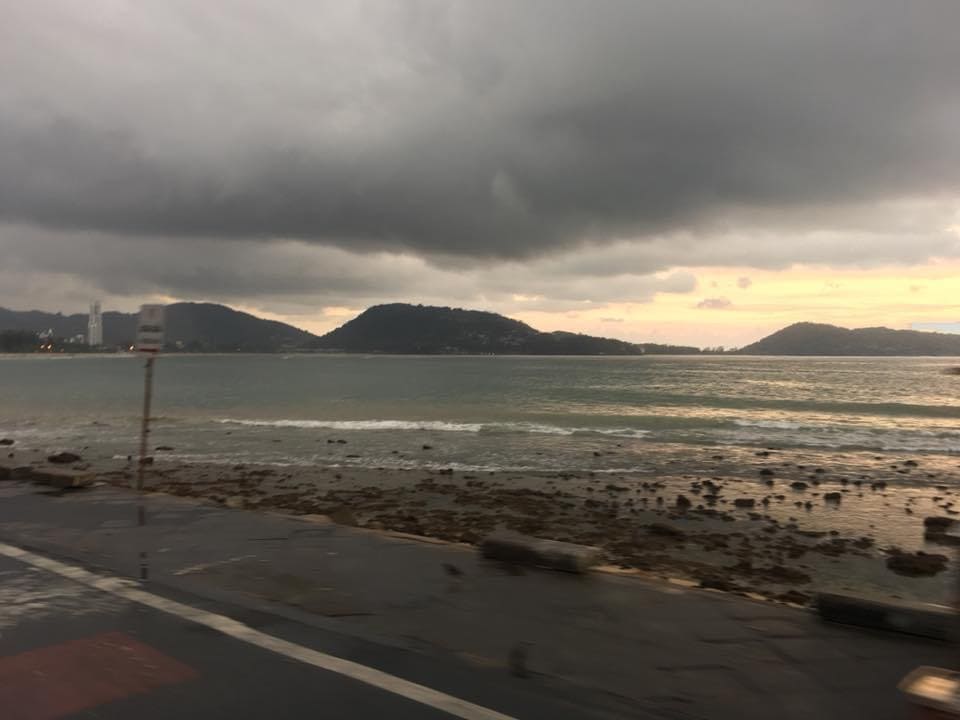 Driving in a car in Phuket with a storm over the sea
