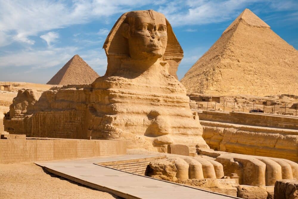A beautiful profile of the Great Sphinx including the pyramids of Menkaure and Khafre in the background in Giza Cairo Egypt