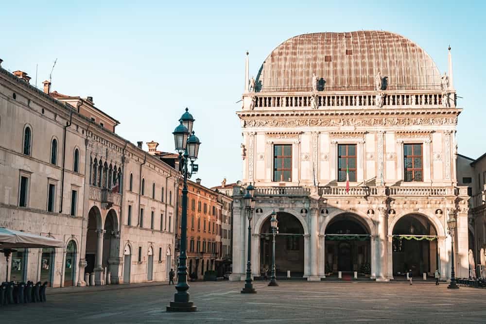 Beautiful historic building in Italian plaza during sunrise with warm light.