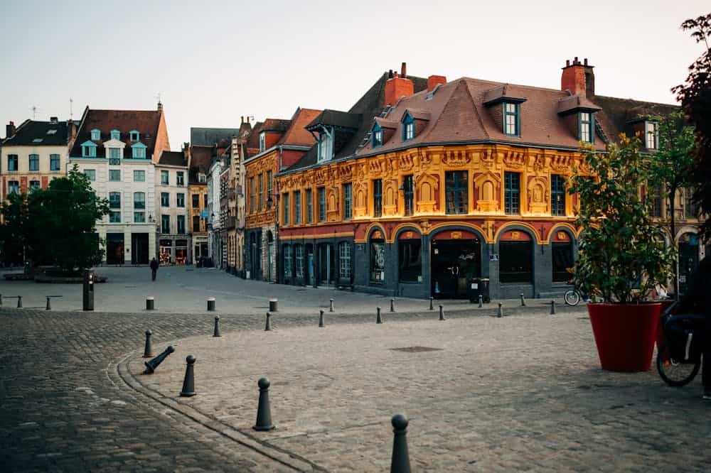 Colorful cityscape of Lille showcasing historic mannerist architecture in an open urban square.