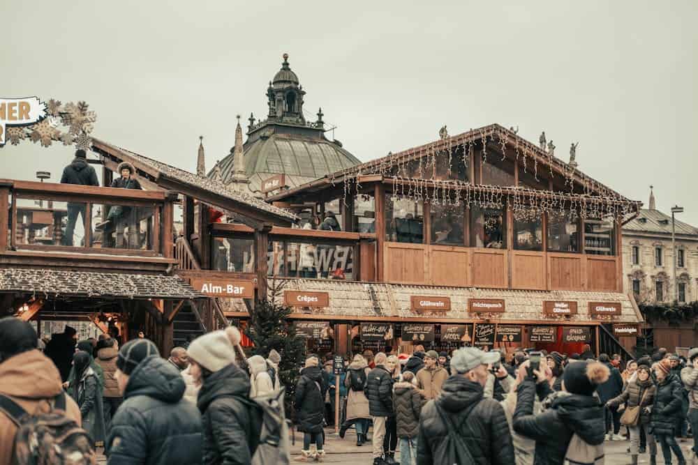 Festive atmosphere at Munich's famous Christmas market with crowds and decorations.